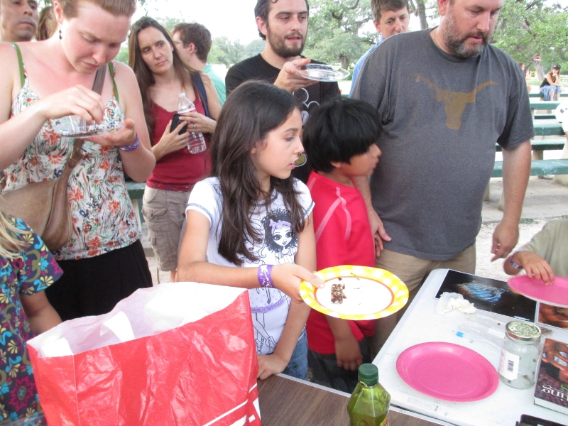 Kids crowd the tables to get to eat bugs at the Austin Bug Festival (PRNewsFoto/Little Herds)