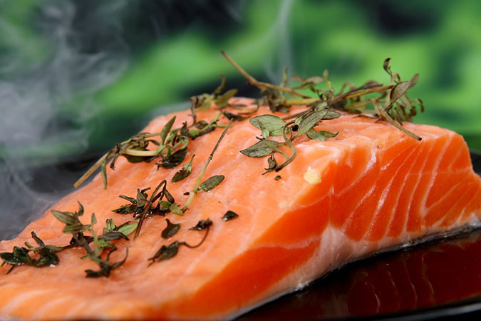Eat wild-caught salmon and other fish high in omega-3 fatty acids to help prevent gum disease (The Grow Network)
